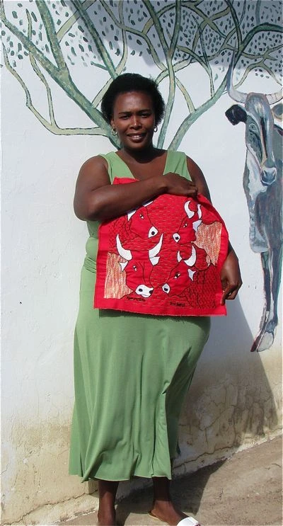 keiskamma-stitcher-with-red-cow.jpg