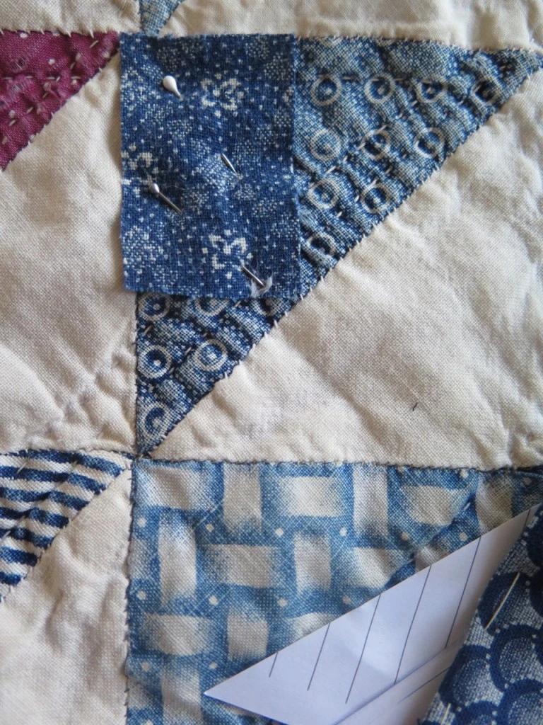 indigo blue cotton quilt being patched